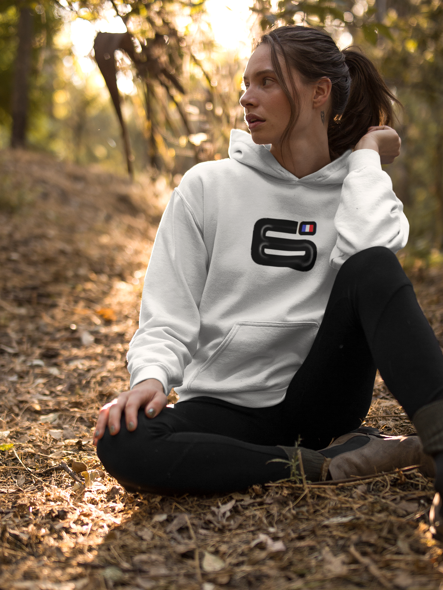 Girl resting in the woods wearing a pullover hoodie mockup a17907